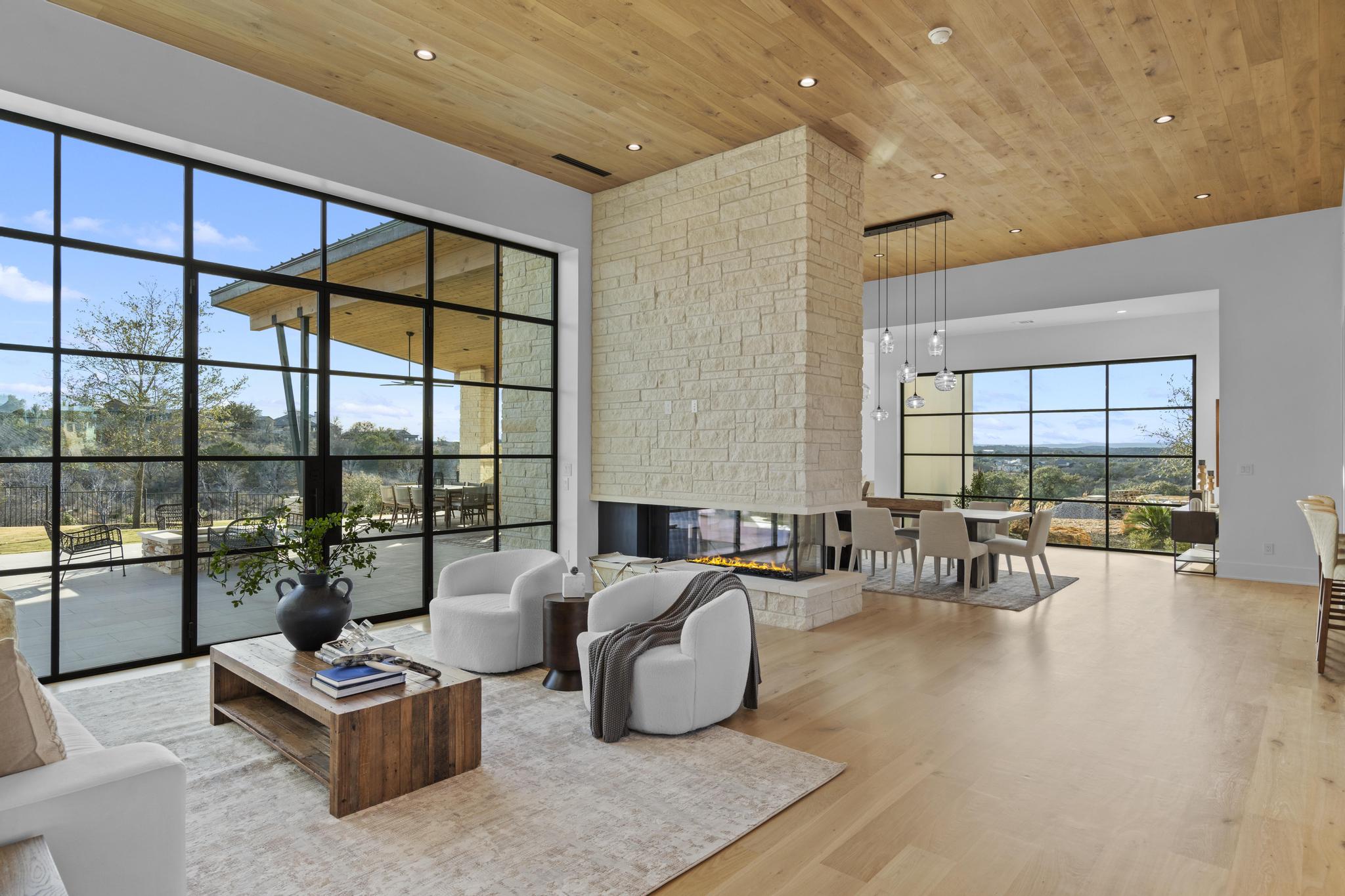 Great room with double-sided fireplace and steel-framed glass