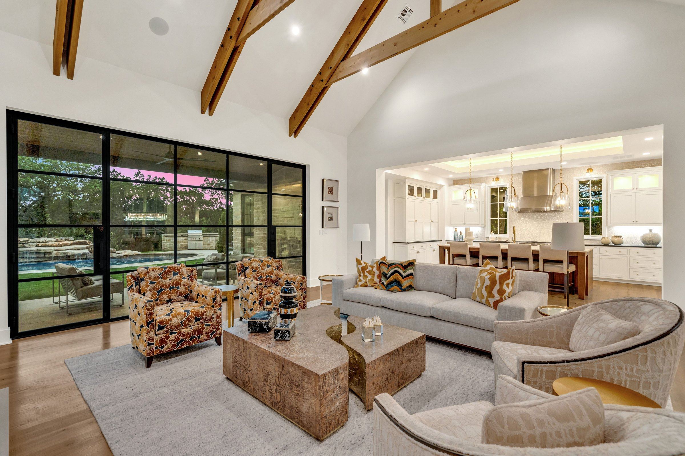 Great room at 4300 Amarra Drive with twilight visible through the windows